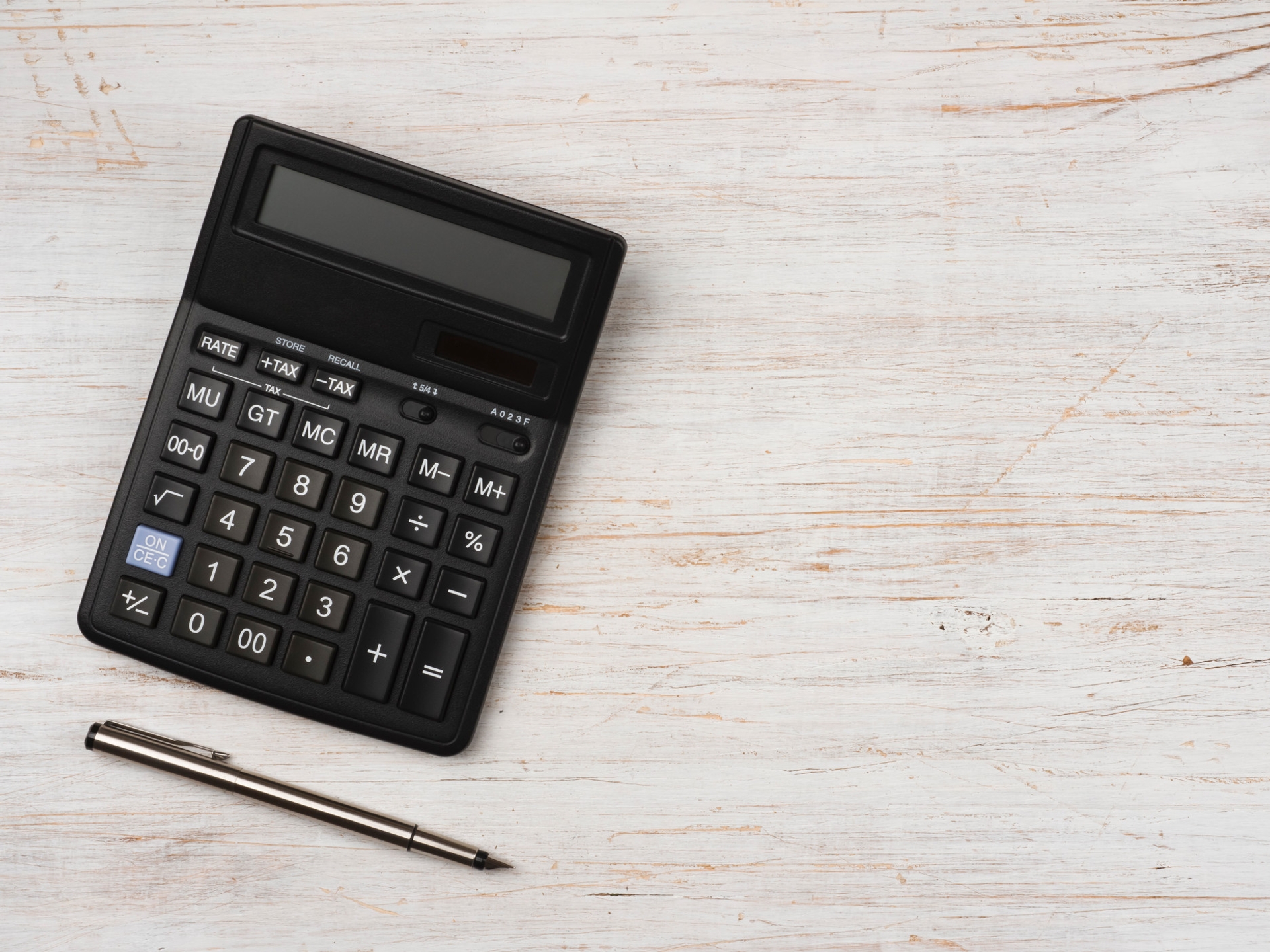 Calculator and pen on a desk