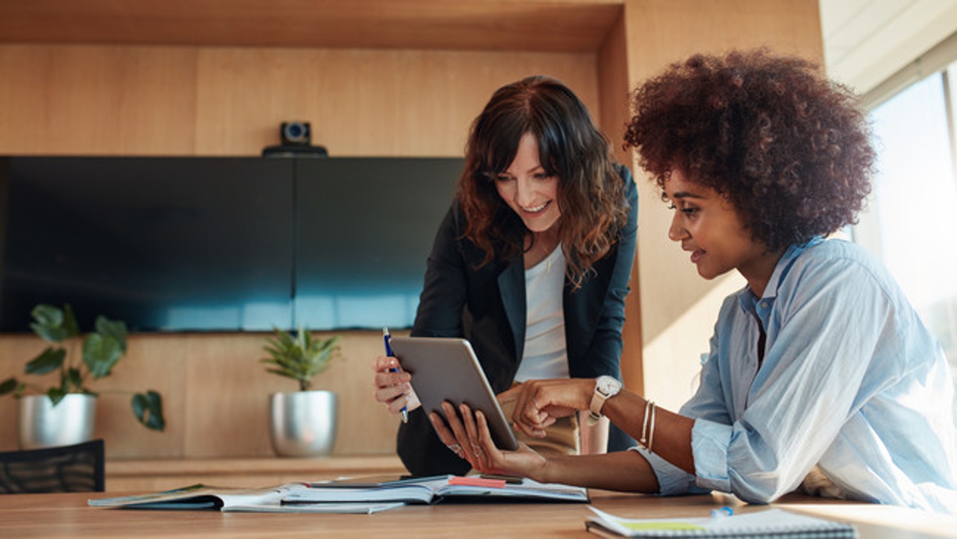 Women working at laptops in kitchen