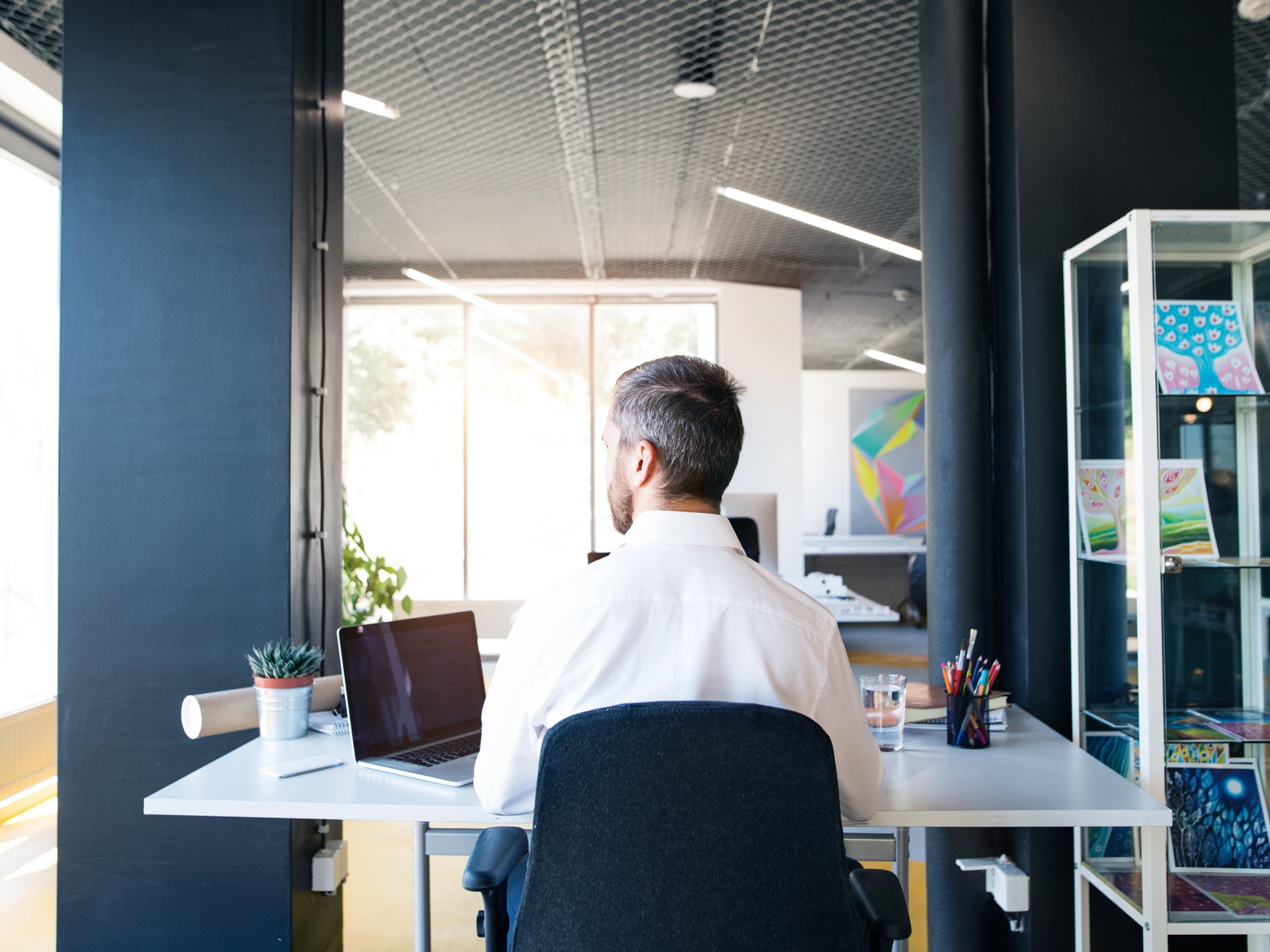 Man working at desk with back to us