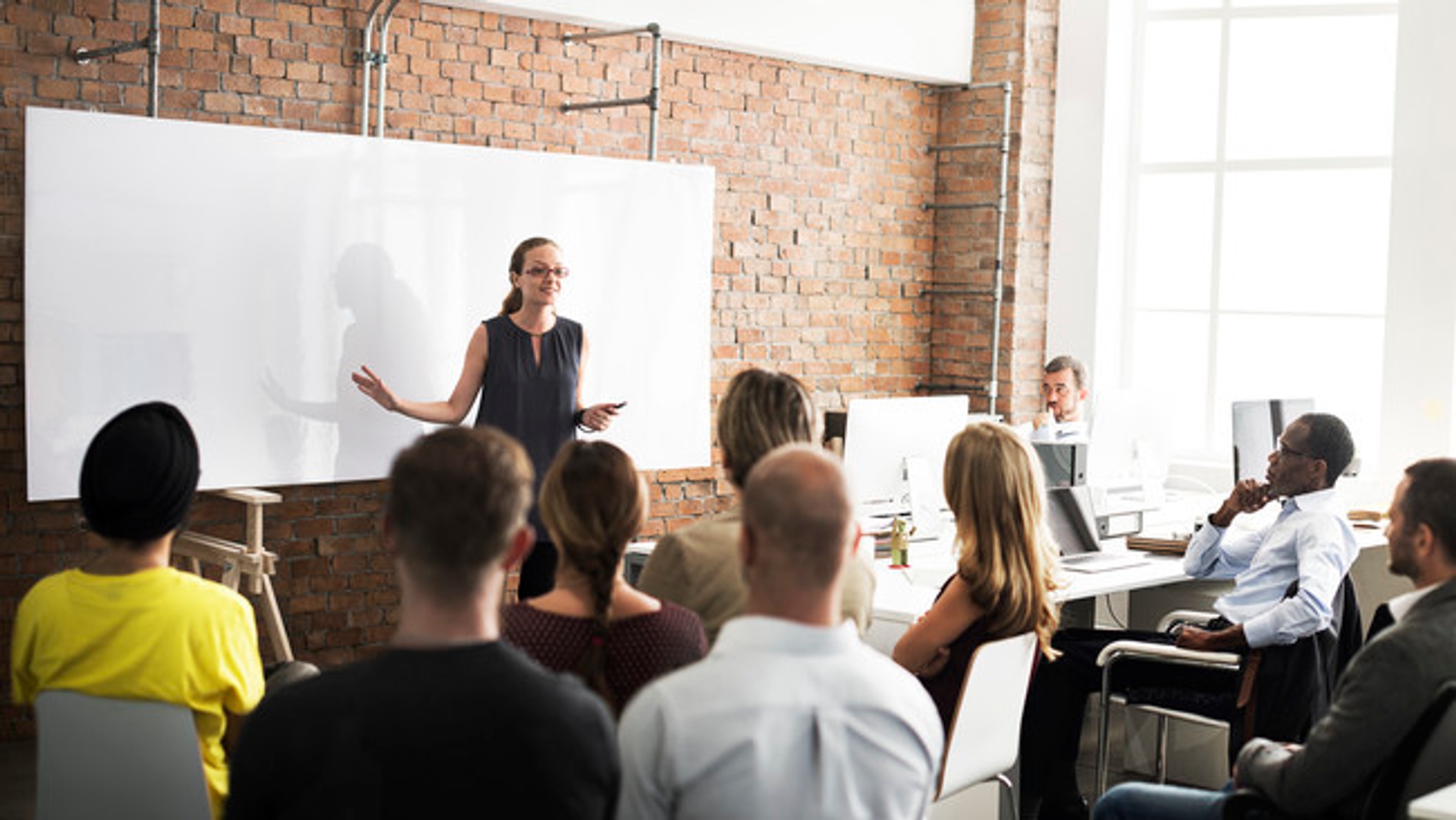 image: instructor addressing a class